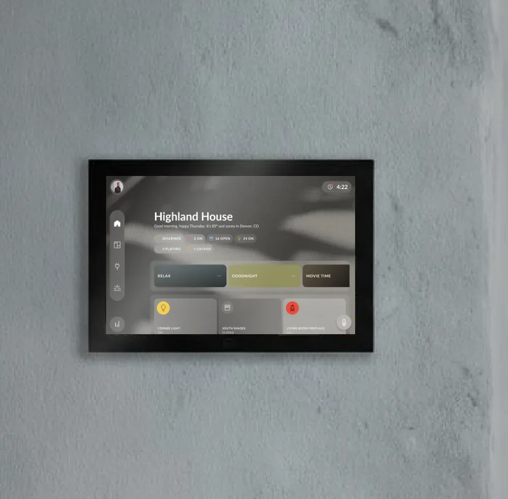 A Josh Touchscreen mounted on a plaster wall showing room scenes